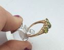 Picture of 14kt yellow gold ring with 4 small diamonds and 3 oval peridots 3.4 gr size 10 .843653-1. 
