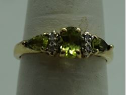 Picture of 10KT YELLOW GOLD RING WITH  4 DIAMONDS 0.02PTS AND 3 PERIDOTS  (1 OVAL; 2 PEAR SHAPE).1.8GR SIZE 7.25 VERY GOOD CONDITION. PRE OWNED.