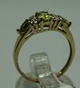 Picture of 10KT YELLOW GOLD RING WITH  4 DIAMONDS 0.02PTS AND 3 PERIDOTS  (1 OVAL; 2 PEAR SHAPE).1.8GR SIZE 7.25 VERY GOOD CONDITION. PRE OWNED.