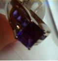 Picture of 14kt white gold ring 6.9 grams total weight . Pre owned. Great condition . With 16 small round diamonds , 8 small princess cut amethysts and centered princess cut amethyst stone.  845441-2 