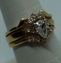 Picture of 14kt yellow gold wedding ring soldered together with diamonds ( 1 centered pear shaped diamond 0.39pt  & 14 round diamonds 0.40pts ) 5.7gr size 8.  very good condition. i-5953. 