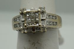 Picture of 14KT WHITE GOLD RING 5.5GR WITH 0.75PTS OF DIAMONDS (16 ROUND DIAMONDS ; 8 BAGUETTES; 9 PRINCESS CUT ) SIZE 5.25 GOOD CONDITION. PRE OWNED. 796205-1. 