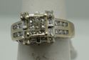 Picture of 14KT WHITE GOLD RING 5.5GR WITH 0.75PTS OF DIAMONDS (16 ROUND DIAMONDS ; 8 BAGUETTES; 9 PRINCESS CUT ) SIZE 5.25 GOOD CONDITION. PRE OWNED. 796205-1. 