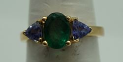 Picture of 14kt yellow gold ring with emerald and tanzanites . Size 6.5 . Total weight 3.3gr. very good condition. Pre owned. Oval emerald and 2 tanzanites . 845374-2. 