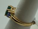 Picture of 14kt yellow gold ring with emerald and tanzanites . Size 6.5 . Total weight 3.3gr. very good condition. Pre owned. Oval emerald and 2 tanzanites . 845374-2. 