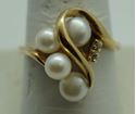 Picture of 14kt yellow gold ring size 9.5 with pearls and diamonds . 2 diamonds small. 4 pearls . Total weight 5.6gr. Pre owned. 838381-1.