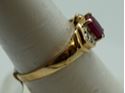 Picture of 10kt yellow gold ring with red stone size 7.25 total weight 2.0 gr . Pre owned.  840097-1.