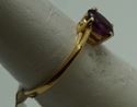 Picture of 14kt yellow gold ring with oval purple stone 1.5gr. pre owned very good condition size 5.75 very good condition. 809422-1. 