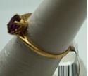 Picture of 14kt yellow gold ring with oval purple stone 1.5gr. pre owned very good condition size 5.75 very good condition. 809422-1. 