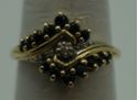 Picture of 10kt yellow gold ring size 7 w 3 diamonds 0.03pts & 14 bround blue stones 2.3 gr. pre owned. very good condition. 849494-1. 