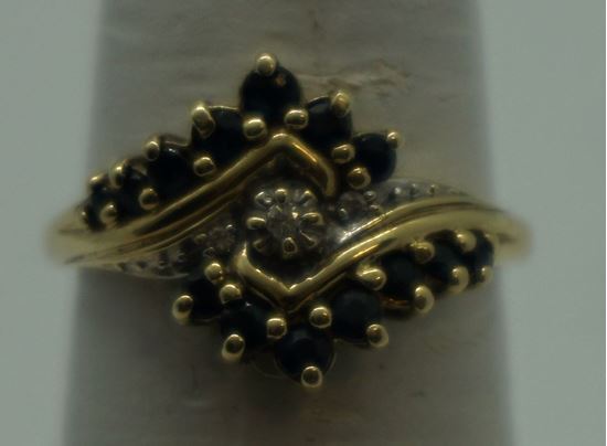 Picture of 10kt yellow gold ring size 7 w 3 diamonds 0.03pts & 14 bround blue stones 2.3 gr. pre owned. very good condition. 849494-1. 