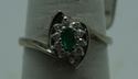 Picture of 14kt white gold ring size 7.5 2.8gr with 10 round diamonds 0.25pts  and marquise emerald 0.10pts. pre owned. very good condition.