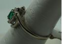 Picture of 14kt white gold ring size 7.5 2.8gr with 10 round diamonds 0.25pts  and marquise emerald 0.10pts. pre owned. very good condition.