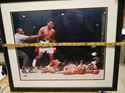 Picture of " MUHAMMAD ALI KNOCKS OUT SUNNY LISTON" . AUTOGRAPHED. FRAME SIZE 22X25 . PICTURE SIZE 19X22. WITH GRANDSTAND SPORT HOLOGRAM, ONLINE AUTHENTIC HOLOGRAM .