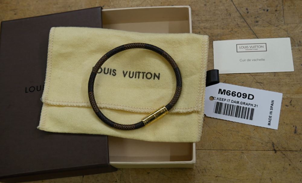 Cash USA Pawnshop. Louis Vuitton cowhide leather bracelet M6609D pre owned  with case and dust bag. pre owned. very good condition.