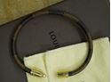 Picture of Louis Vuitton cowhide leather bracelet M6609D pre owned with case and dust bag.  pre owned. very good condition. 